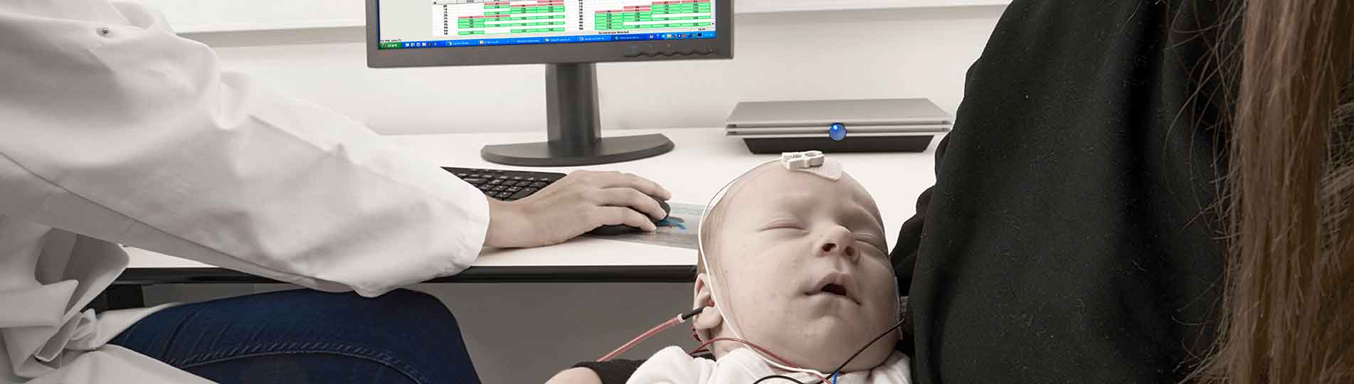 ASSR hearing test in baby lying down in mother's arms