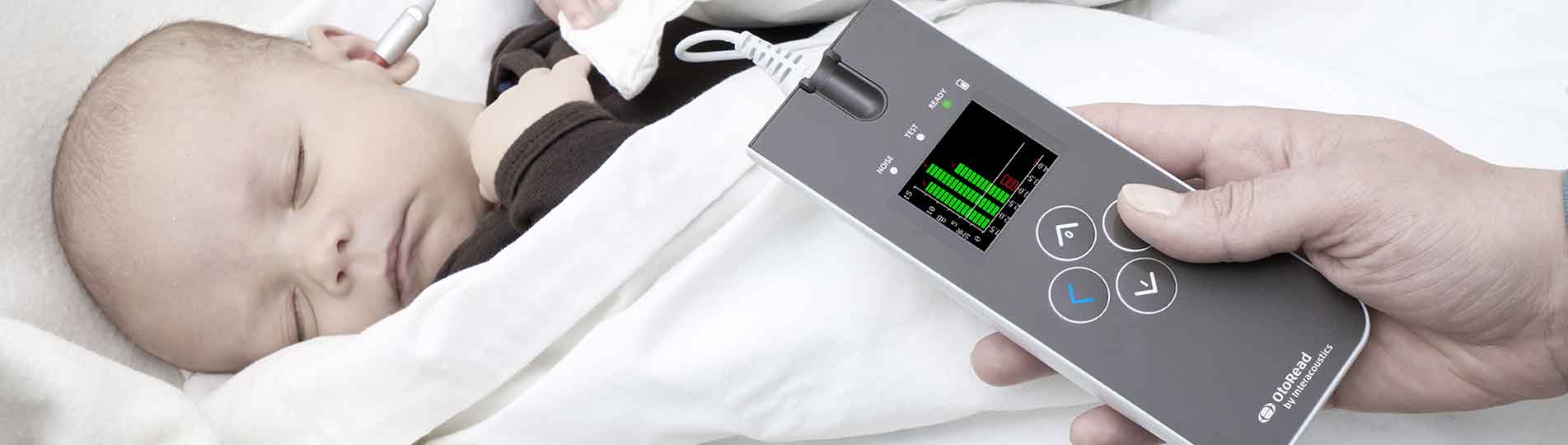 Clinician performing OAE screening in baby with the OtoRead device
